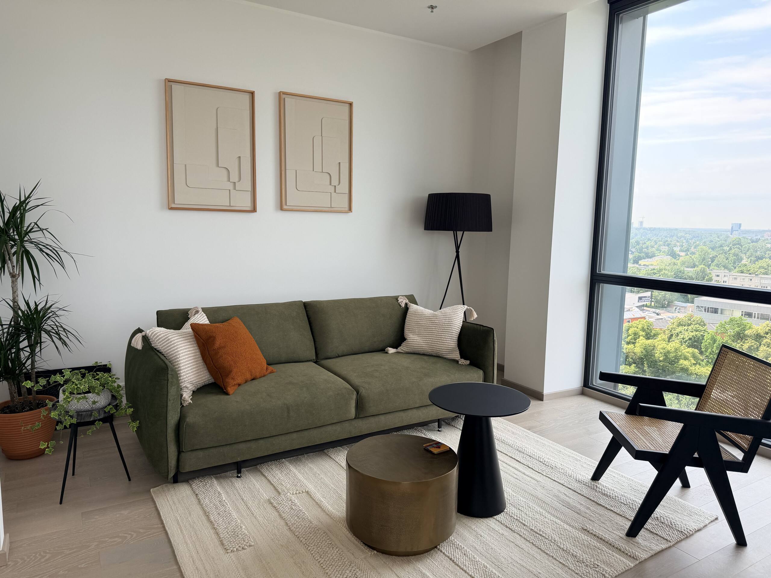 Corner of the living room with natural wood tones and a reading lamp.